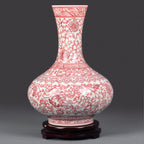 Full profile of the underglaze red lotus-scroll vase on a dark wood base