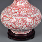 Close view of underglaze red lotus scrolls across the porcelain body