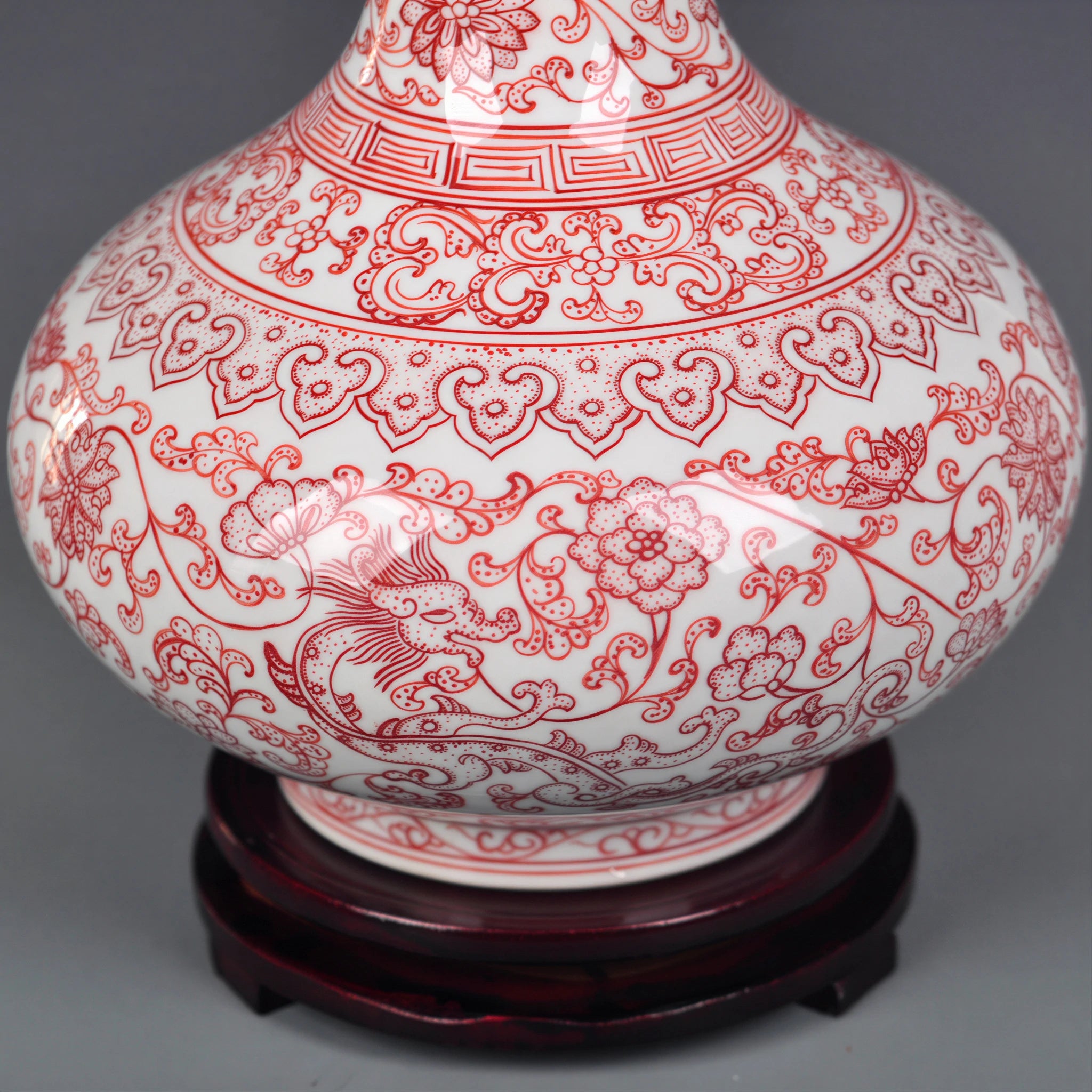 Close view of underglaze red lotus scrolls across the porcelain body
