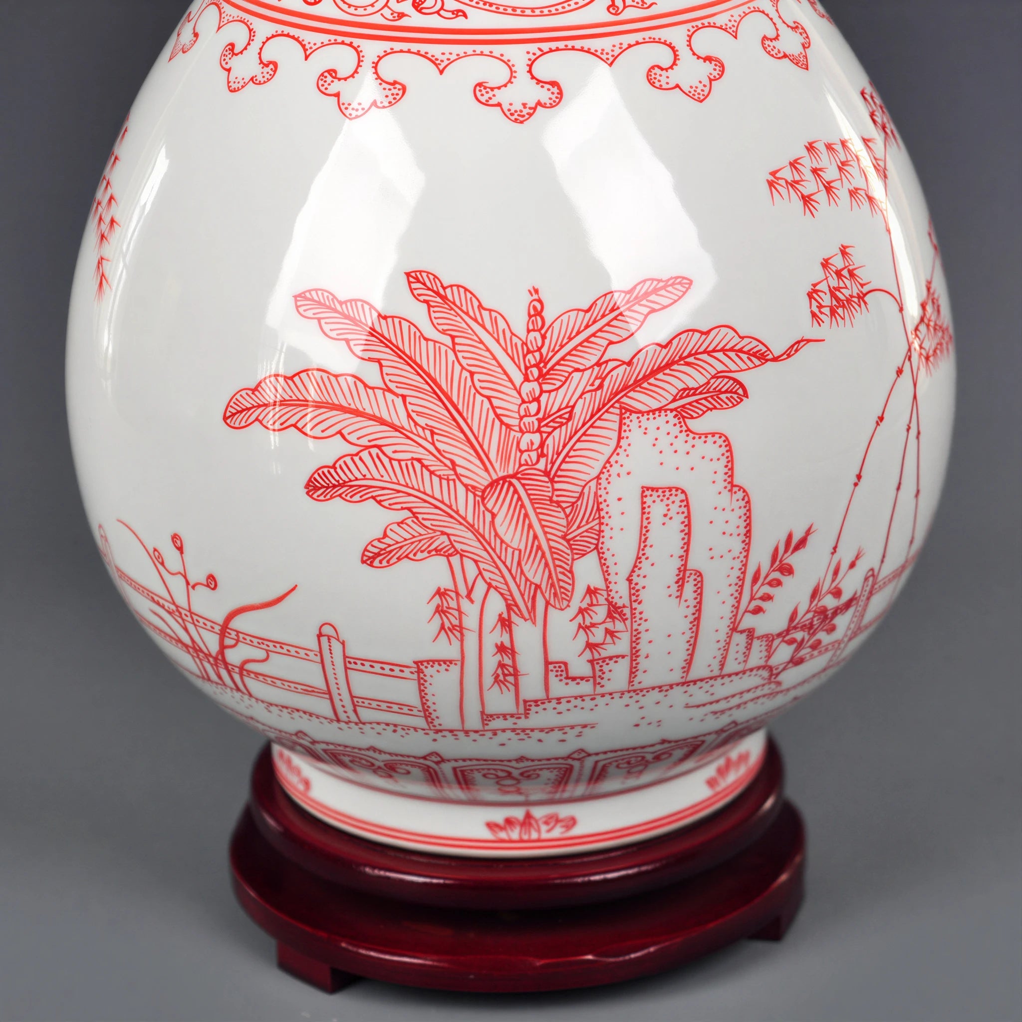 Close view of underglaze-red plantain leaves, garden rock and balustrade