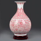 Full profile of the underglaze red Yuhuchun vase on a dark wood base