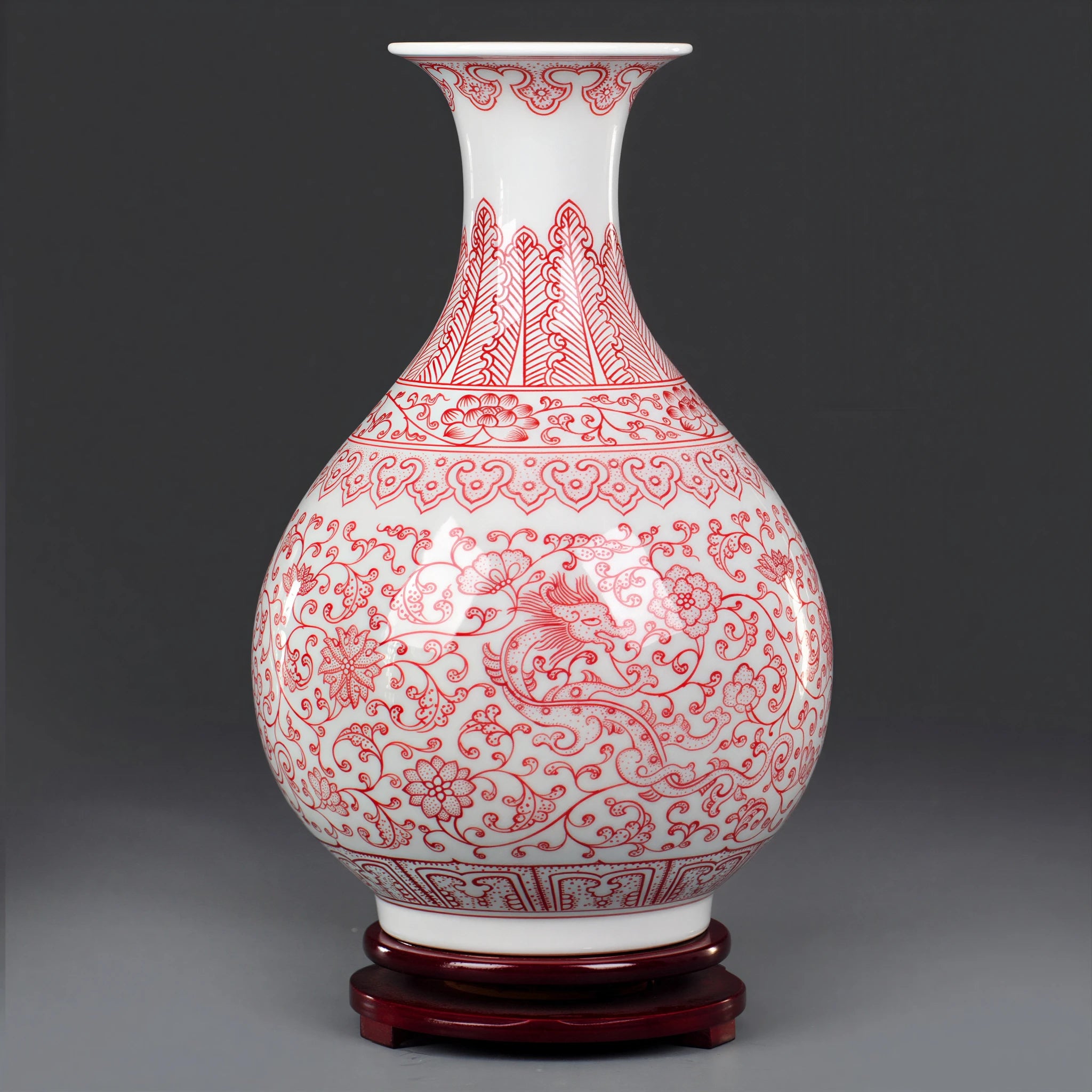 Full profile of the underglaze red Yuhuchun vase on a dark wood base