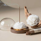 Angled view of the carnation, wood base, dome and incense tube