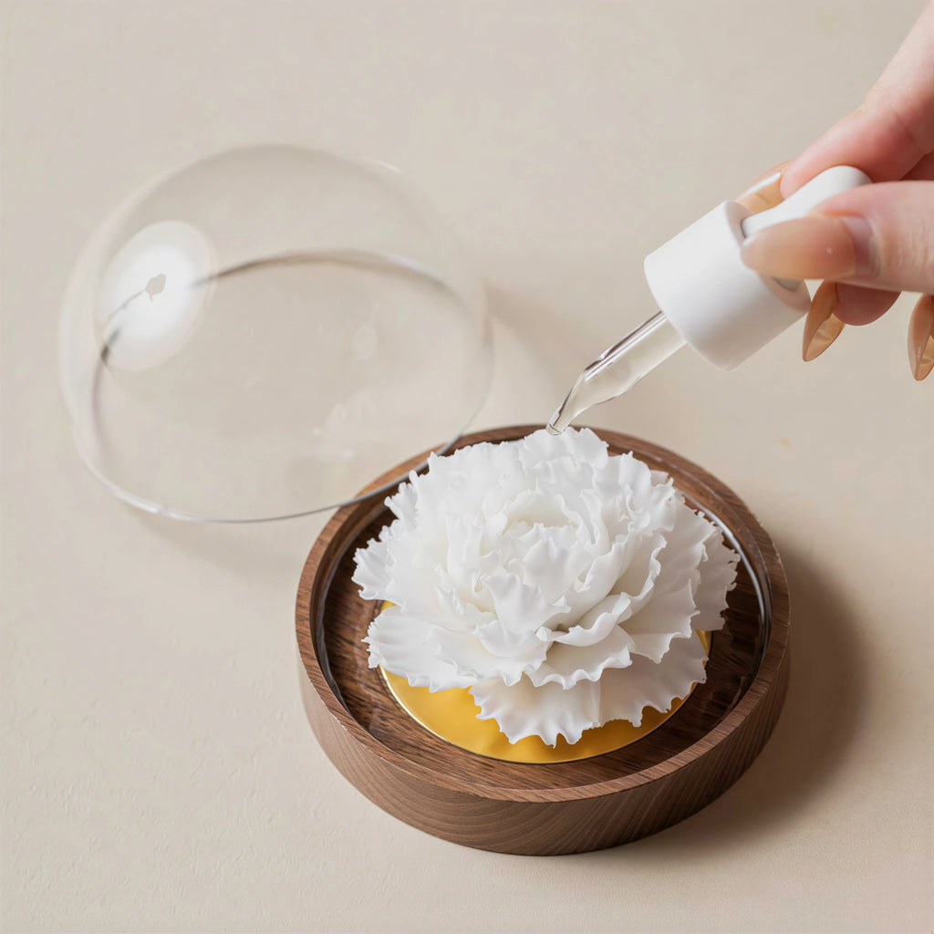 Fragrance oil being applied to the white porcelain carnation