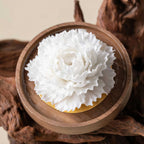 Close view of the densely ruffled white porcelain petals