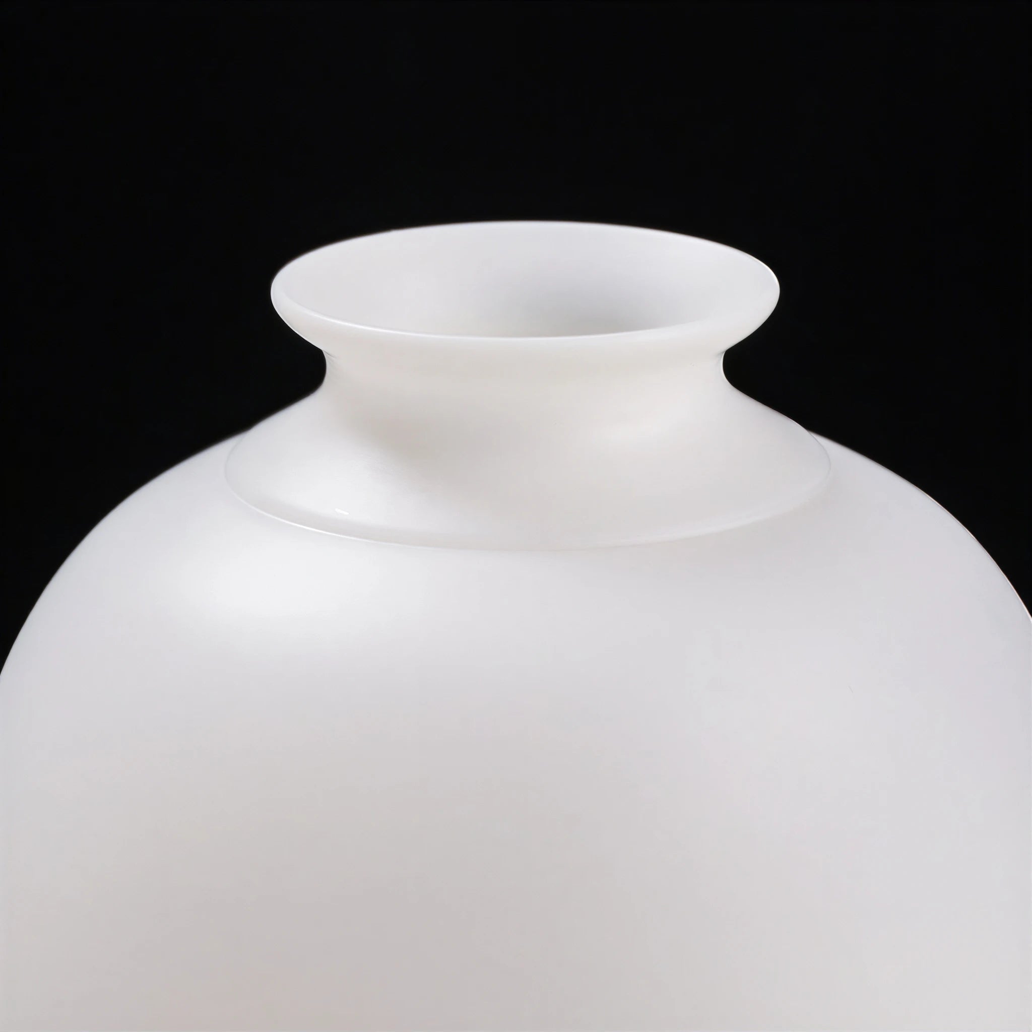 Close view of the flared mouth and smooth white shoulder of the hydrangea Meiping vase