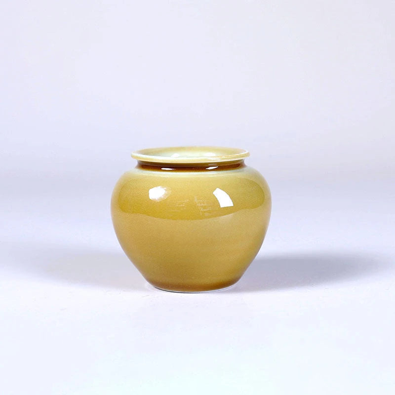 Front view of a wide-mouth luminous yellow porcelain vase