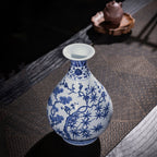 Blue-and-white Yuhuchun vase displayed on a tea table with pine, bamboo and plum decoration