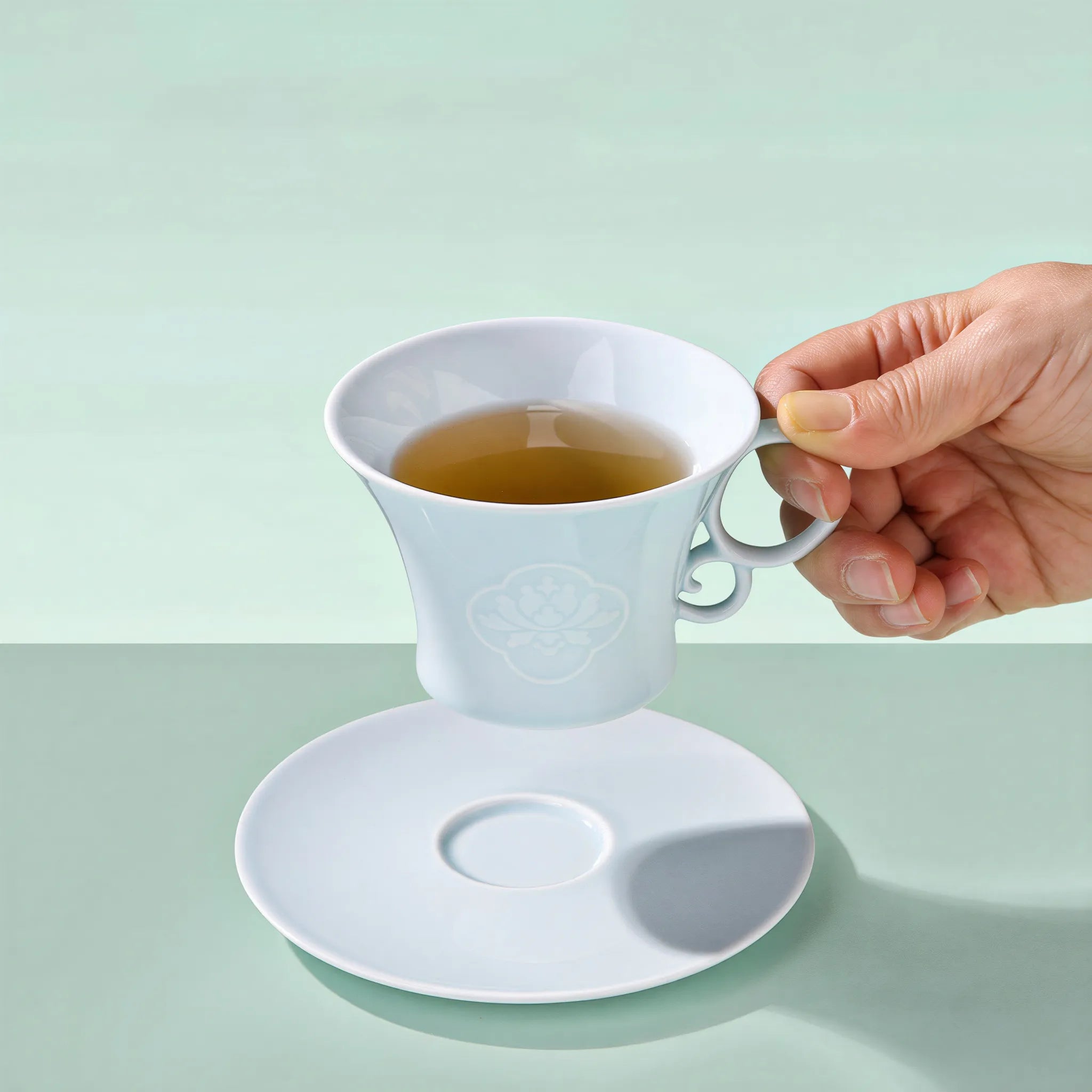 Yingqing carved peony cup in a quiet table setting