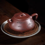 Yixing zini Shipiao teapot with a carved landscape
