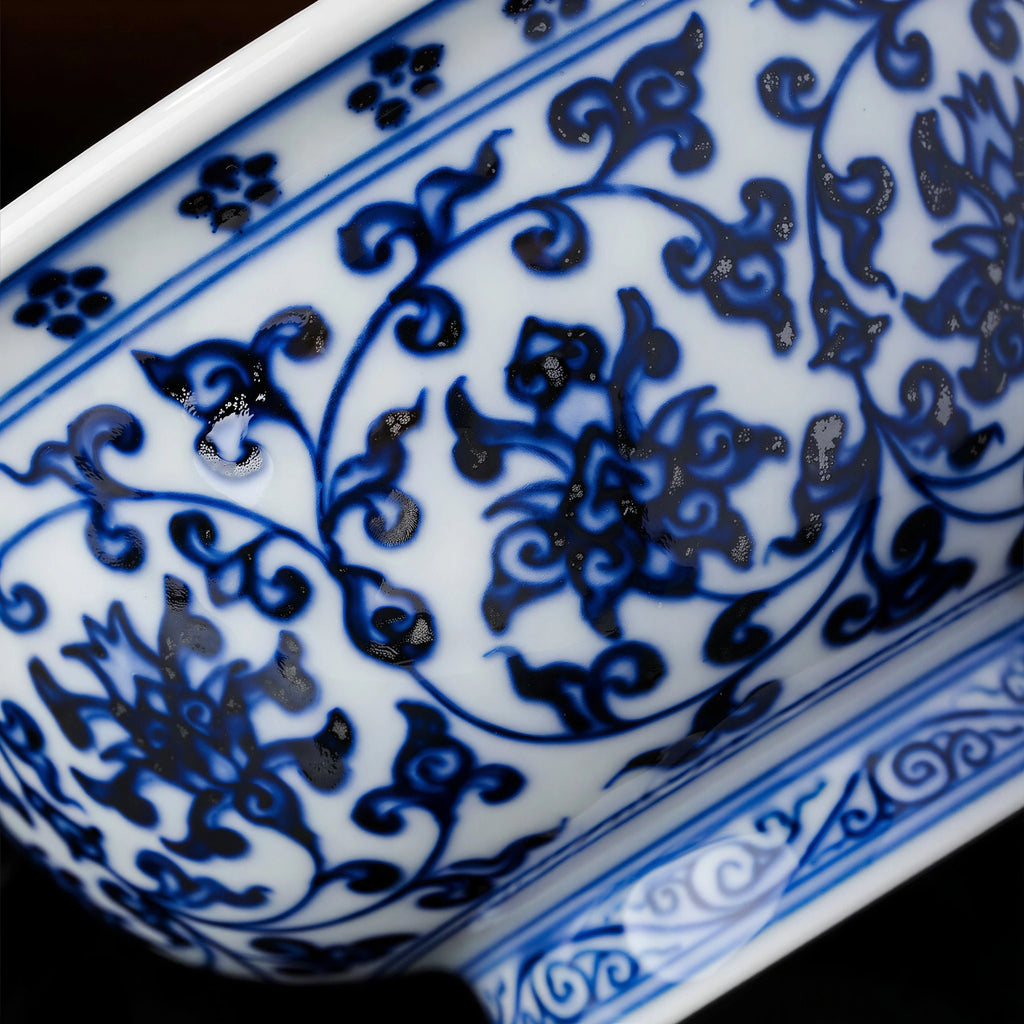 Close view of cobalt lotus scrolls and darker pigment gathering