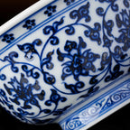 Close view of cobalt lotus scrolls and darker pigment gathering