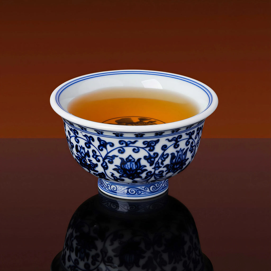 Blue-and-white press-hand cup shown with other teaware for scale