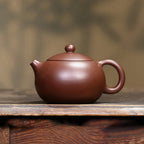 Zini Xishi teapot displayed on a wood tea table
