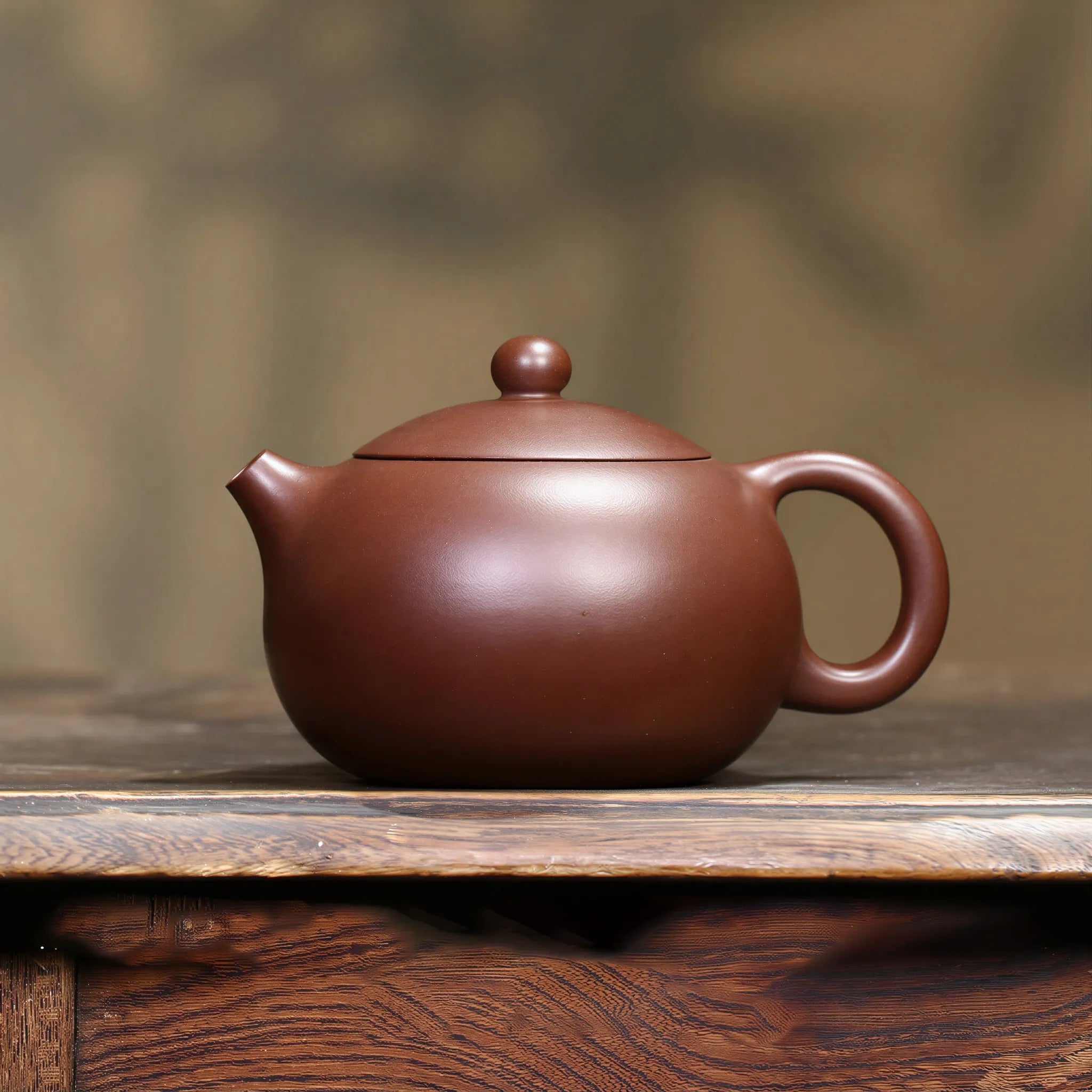 Zini Xishi teapot displayed on a wood tea table